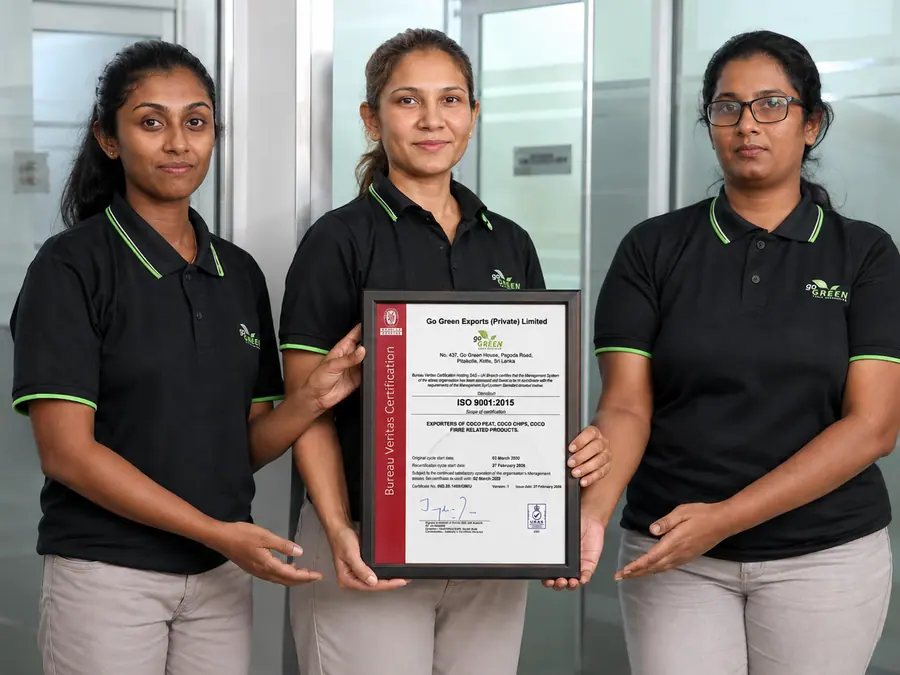 Go Green Exports team members holding the framed Bureau Veritas ISO 9001:2015 certificate